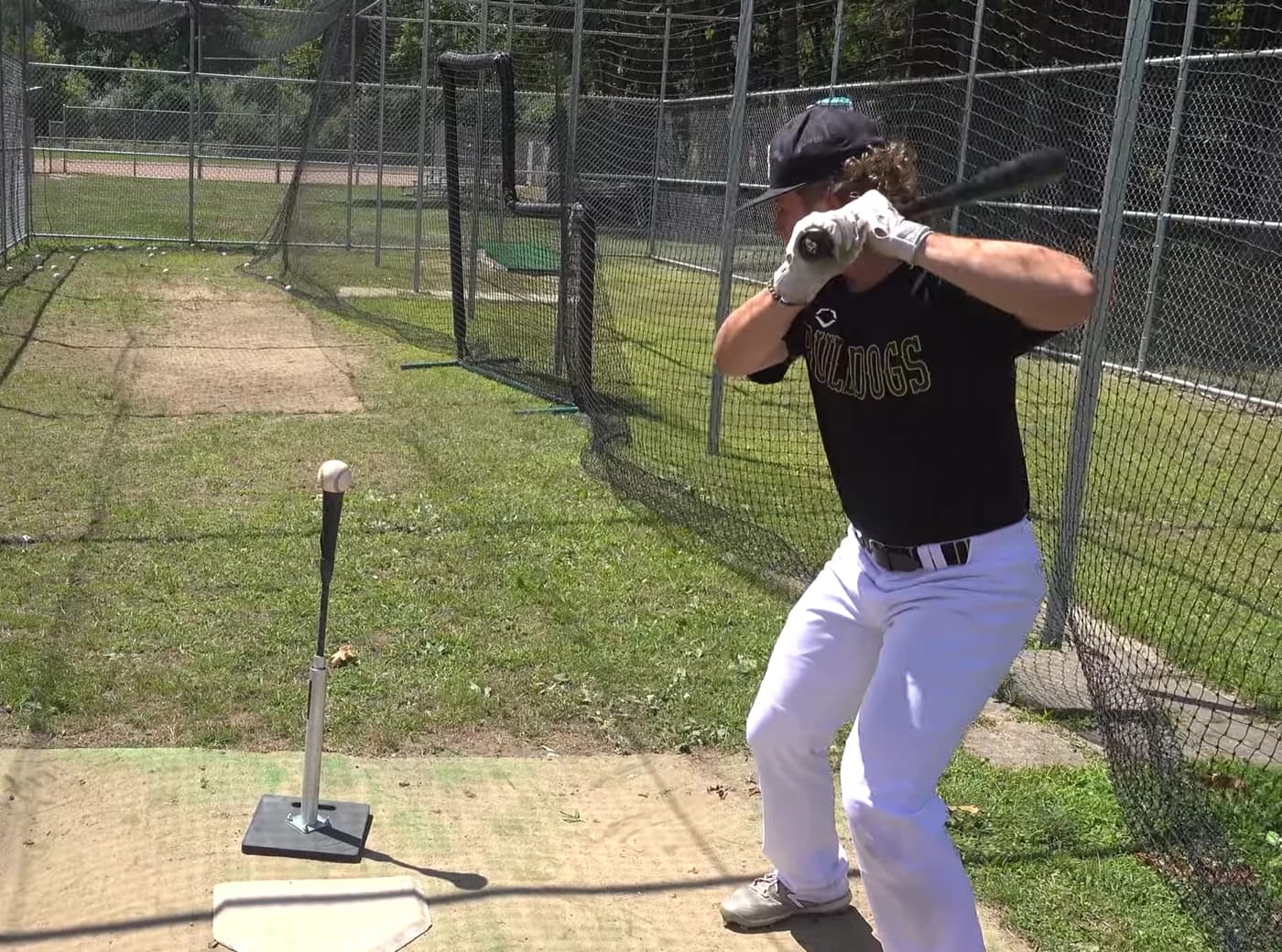 Travis Ilitch practicing his baseball swing in a batting cage