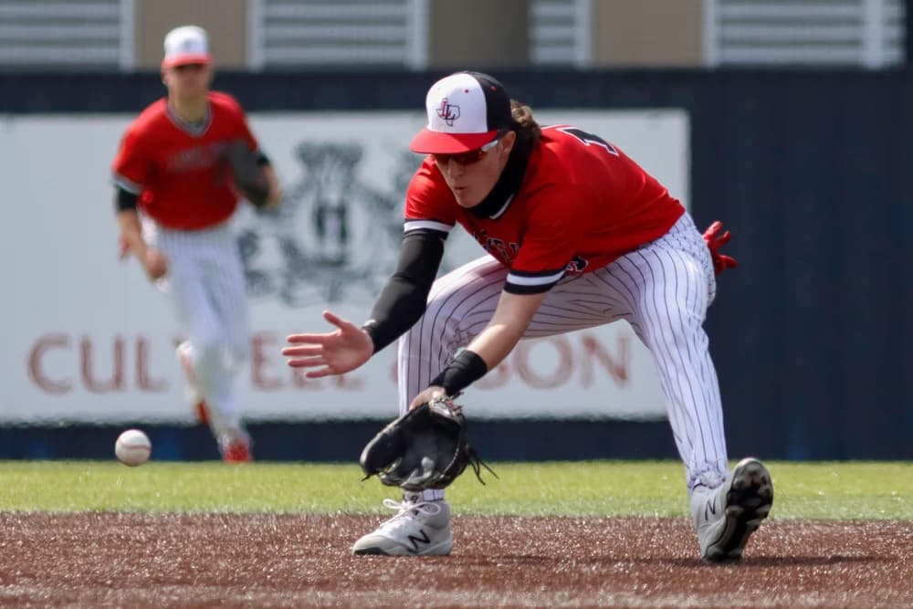 Baseball athlete fielding a ground ball