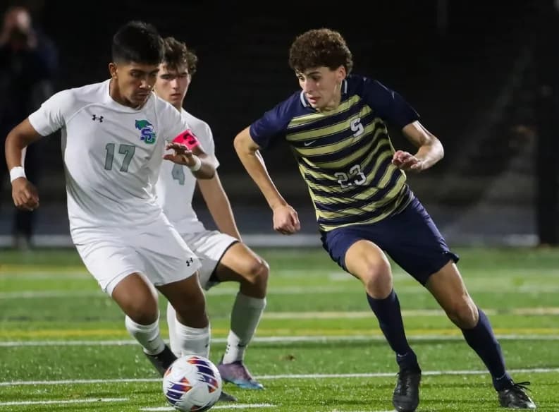 Soccer athletes challenging for the ball