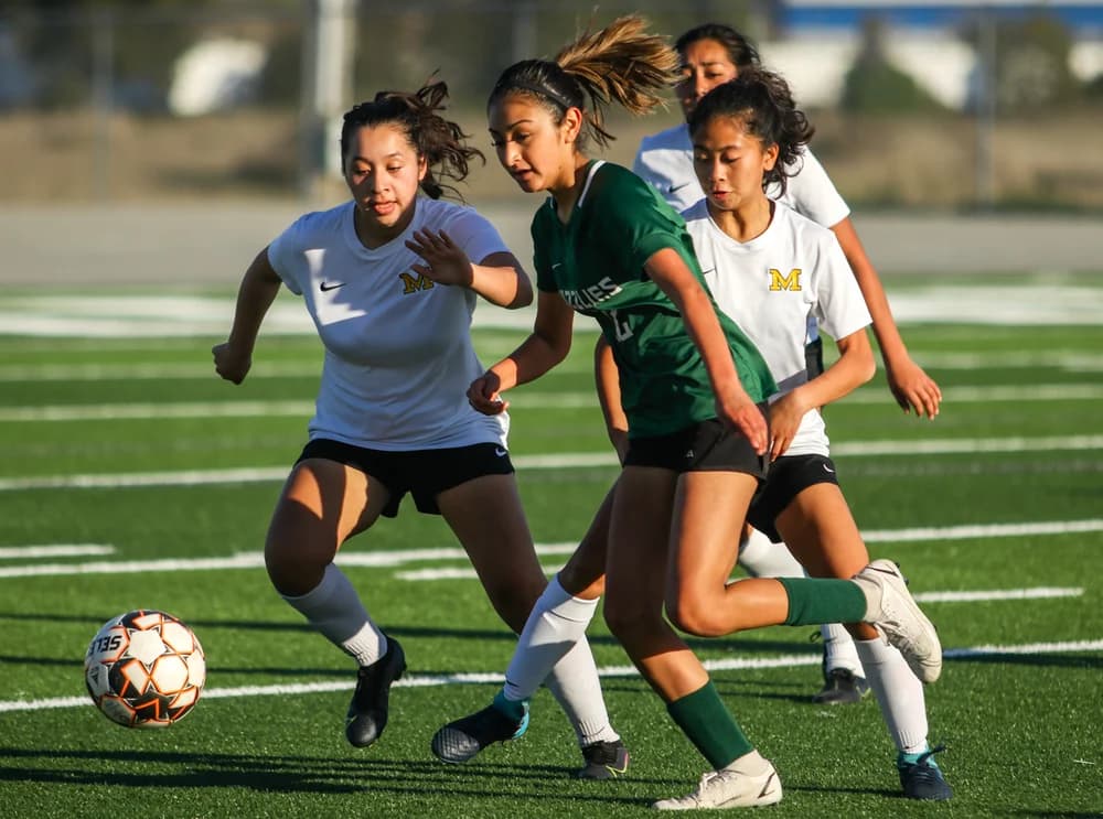 Soccer athletes competing for possession